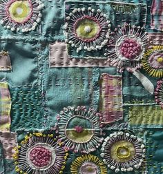 a patchwork piece with flowers and circles on it's side, in pastel colors