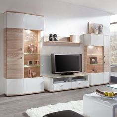 a modern living room with white and wood furniture