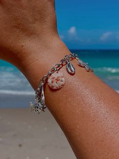 The Scallop shell included on this charm bracelet was found by me on Jupiter Beach, Florida. The silver plated charms used are inspired by marine life. Each stainless steel bracelet is 8.07 inches long and has a toggle clasp. Charms and shells vary. Jupiter Beach Florida, Jupiter Beach, Beach In Florida, Coquille Saint Jacques, Scallop Shell, Saint Jacques, Scallop Shells, Silver Charm Bracelet, Beach Florida