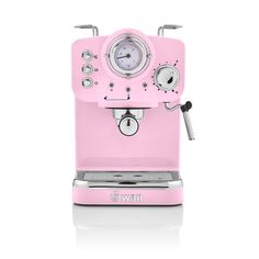 a pink coffee machine sitting on top of a white table