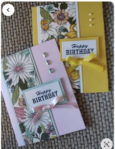 two cards with flowers on them are sitting next to each other and one has a tag that says happy birthday