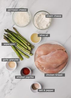 ingredients for chicken and asparagus recipe laid out on a white marble counter top