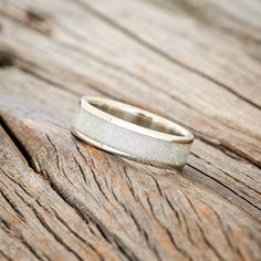 a wedding ring sitting on top of a wooden table