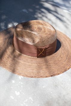 The most beautiful straw panama we've ever carried!! The glamorous Riviera hat is the perfect straw hat to offer full sun protection. Its body is braided by artisan hands and interlaced with palm leaves to create the finished design. Hat has a sealer on it making it water resistant. The construction of this hat is incredible. It’s completed with a rustic cotton braided trim. Features an inner elastic band for a OSFM fit! 100% Palm leaf, natural color (One Size) Standard Medium 58 cm Crown 4” Bri Luxury Wide Brim Fedora For Beach, Luxury Wide Brim Fedora For The Beach, Luxury Fedora Straw Hat For Beach, Luxury Fedora Straw Hat For The Beach, Luxury Toquilla Straw Hat, Luxury Beach Fedora With Curved Brim, Luxury Curved Brim Fedora For Beach, Luxury Curved Brim Fedora For The Beach, Luxury Straw Hat With Curved Brim