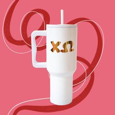 a white cup with the word xo printed on it and a straw sticking out of it