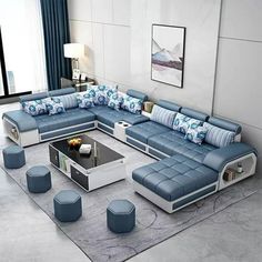 a modern living room with blue and white furniture in it's centerpieces