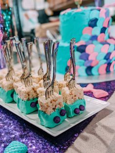 there are many forks stuck in rice on the plate with purple and blue decorations around it