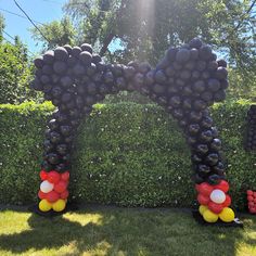 mickey mouse balloon arch with balloons in the shape of ears