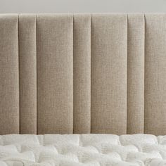 an upholstered headboard with no sheets on it