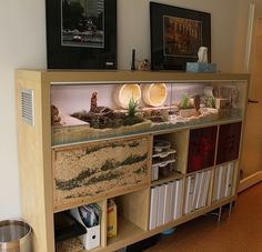 an aquarium is on top of a book shelf