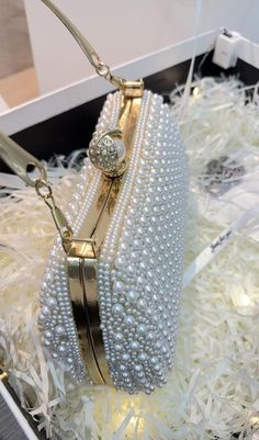 Get ready to shine with our Rhinestone Pearl Beaded Clutch! This clutch is embellished with dazzling rhinestones and pearls, adding a touch of glamour to any outfit. Perfect for special occasions or a night out, this clutch will surely make a statement. Gold Pearl Clutch For Parties, Party Gold Pearl Clutch, Gold Pearl Party Clutch, Formal Gold Clutch With Pearl Material, Pearl Embroidered Party Clutch, Pearl Clutch With Pearl Embroidery For Evening, Gold Pearl Clutch With Pearl Embroidery, Gold Clutch With Pearl Embroidery, Embellished Pearl Evening Bag