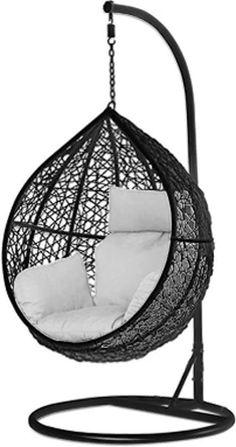 a black hanging chair with white pillows