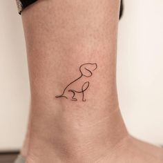 a small dog tattoo on the ankle