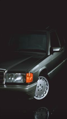 a car parked in the dark with its lights on