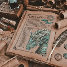 an old book with a dragon on it surrounded by other books and paper machs