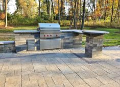 an outdoor bbq with grill and seating area