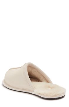 Slide into comfort with a faux fur lined slipper with clasic Ugg style. Round toe Slip-on Faux fur lining Leather upper, faux fur (80% wool, 20% lyocell) lining, manmade sole Imported Casual Sheepskin Indoor Slippers, Casual Indoor Sheepskin Slippers, Soft Casual Sheepskin Slippers, Classic Indoor Slippers, Classic Indoor Slippers With Cushioned Footbed, Ugg Style, Slide Slipper, Womens Slippers, Faux Fur