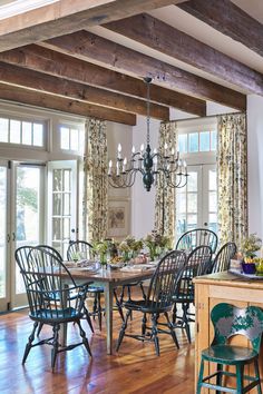 a dining room table with chairs and a chandelier