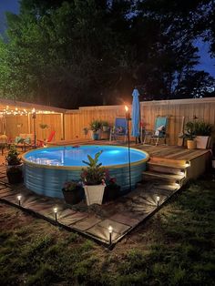 an above ground swimming pool surrounded by lights