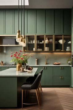 a kitchen with green cabinets and white counter tops, two black chairs in front of the island