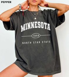 This Minnesota college varsity comfort colors shirt is super soft and cozy. Perfect to lounge around, run errands, or walk your dog. ABOUT THIS SHIRT   ∙ Shirt is UNISEX and runs slightly large for ladies (For a relaxed fit, I suggest your usual size. For an oversized fit, I suggest sizing up 1 to 2 sizes.) ∙ 100% ring spun medium-weight cotton (soft-washed and garment-dyed) ∙ Colors may vary based on your monitor/screen display or lighting CARE INSTRUCTIONS ∙ Machine wash inside out in cold wat Casual Comfortable Fit T-shirt With Letter Print, Casual Gray T-shirt For College, Casual Relaxed Fit Tops For Campus, Casual Tops With Relaxed Fit For Campus, Sporty Relaxed Fit Top For Campus, Comfortable Crew Neck T-shirt With Letter Print, Relaxed Fit Letter Print Top For Campus, Relaxed Fit Tops With Letter Print For Campus, Sporty Cotton Top For Campus