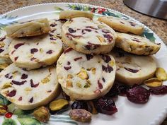 a white plate topped with cookies and dried cranberries