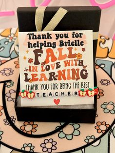 a thank card with an image of a teacher's quote in the center and flowers around it