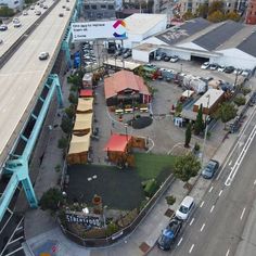 an aerial view of a city with cars and buildings