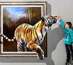 a young boy standing next to a painting of a tiger