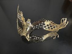 Enchant with our gold couples masquerade masks. The men's mask boasts a Venetian-style charm, while the women's mask is a vision of elegance with rhinestones. Together, you'll create an unforgettable duo that exudes sophistication and allure at any masquerade party or ball!


Age Group/Gender - Adult/Unisex

Size/Type - One size fits all adults

Mask Color - Gold

Mask Material - Men's: Polyresin, Women's: Laser Cut Metal

Accent Material - Paint

Special Features - Rhinestones Gold Carnival Masquerade Eye Mask, Gold Venetian Masquerade Mask For Formal Occasions, Gold Masks For Formal Carnival Occasions, Gold Masks For Carnival And Formal Events, Gold Formal Masks For Carnival, Elegant Formal Mask For Carnival, Elegant Formal Masks For Carnival, Elegant Adjustable Masquerade Mask For Mardi Gras, Gold Adjustable Masquerade Mask