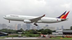 an airplane is taking off from the runway in front of a large cityscape