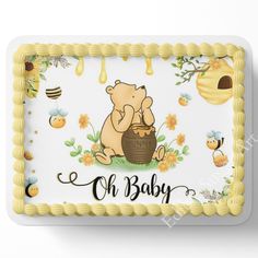 a baby shower cake with a bear holding a honey pot and bees on it's side