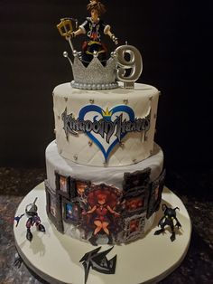 a three tiered cake with an image of kingdom hearts on it