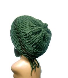 a green knitted hat on top of a mannequin's head,