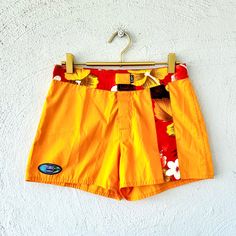 S p e c i f i c s . . . Label: Island X Hawaii  Tagged Size: 5 Approx. Fit: S  Color: Golden Yellow with Orange Hues // Reds // Browns // White Material: Water Resistant Material // Velcro Closure // Pocket Condition: Overall in Amazing New with Tags Vintage Condition Hawaiian Surfing Shorts, Yellow Summer Swim Trunks For Surfing, Yellow Swim Trunks For Summer Surfing, Yellow Swim Trunks For Surfing In Summer, Yellow Swimwear With Built-in Shorts For Vacation, Sporty Yellow Swimming Shorts, Yellow Summer Swim Trunks With Built-in Shorts, Yellow Swim Trunks For Surfing, Yellow Swim Trunks For Surfing Beach Season