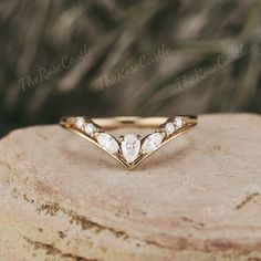 a diamond ring sitting on top of a rock