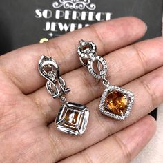 STUNNING 6.17 Total Carats, VIVID orange sapphires and 1.12 carats of F/VS, natural diamonds, set in handmade 12 grams, 18K solid white gold dangling, earrings, with secured omega, latch back. Easy to wear, and comfortable. With natural sapphires and sparkling diamonds, set in one of a kind, 18K Solid white gold, dangling earrings. ONE OF A KIND HANDCRAFTED EARRINGS. IN CASE OF RETURN FOR US BUYERS. BUYERS MAY SEND THE ITEMS BACK TO OUR US-BASED OFFICE IN SALT LAKE CITY, UTAH Our jewelry are spe Gold Dangling Earrings, Golden South Sea Pearls, Blue Sapphire Diamond, Vs Diamond, Orange Sapphire, White Gold Earrings, White Gold Engagement Rings, Dangling Earrings, Handcrafted Earrings