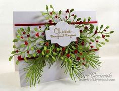 a white card with red berries and green leaves