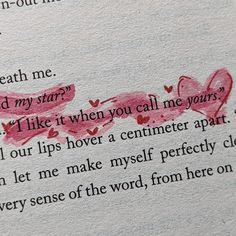 an open book with writing on it and two hearts painted on the pages in red