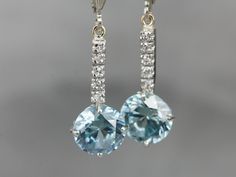 "These lovely zircons are bright and bold! The color is cool, luscious sky blue, with plenty of sparkles! The long bar at the center is inlaid with sparkling diamonds, at the very top are the earring wires, hinged lever backs which are brand new, 14K white gold with a simple polished design. These are comfortable to wear and very secure! Metal: 14K White Gold Gem: 2 Blue Zircon totaling 6.81 Carats Gem Measurements: 8.2 mm, Round Accents: 10 Diamonds totaling .10 Carats, F in Color, VS in Clarit White Gold Drop Earrings, Beautiful Tiaras, Edwardian Jewelry, Earring Wires, Cameo Ring, Fabulous Jewelry, Blue Zircon, Gold Drop Earrings, Jewelry Patterns