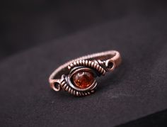 Adorn your fingers with the warm, golden glow of our Handmade Amber Copper Wire Wrapped Ring. Each ring is meticulously handcrafted with a beautiful amber gemstone and wrapped in intricate copper wire, creating a unique and stunning piece of jewelry. Available in any US size and made to order, this ring is the perfect addition to your collection or a thoughtful gift for someone special. Features: Material: Amber gemstone and copper wire Color: Warm golden amber with natural inclusions Design: In Wire Wrapped Rings Intricate, Copper Ring Jewelry For Anniversary, Adjustable Amber Promise Ring, Gold Copper Round Ring, Gold Copper Promise Ring, Copper Wire Wrapped Rings As Gift, Round Copper Jewelry For Anniversary, Handmade Copper Crystal Ring For Gift, Oval Hand Wrapped Rings As A Gift