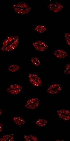 red glitter lip prints on a black background