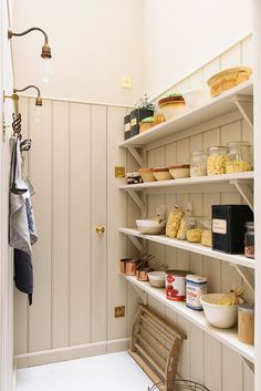 an open pantry with lots of food on the shelves and dishes in bowls next to it