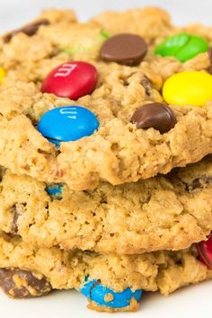 two cookies with m & m's and chocolate chips on top are stacked together