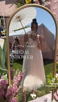 a woman taking a selfie in front of a mirror with the words welcome to bridal shower on it