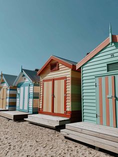 colorful beach huts lined up on the sand