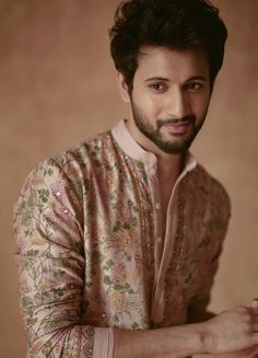 a man with a beard wearing a floral shirt