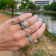 a person's hand with two rings on their fingers and one ring in the middle