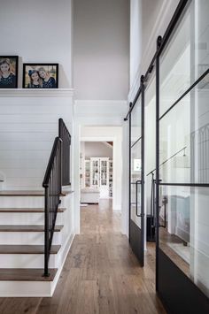 there is a staircase leading up to the second floor in this house with white walls and wood floors