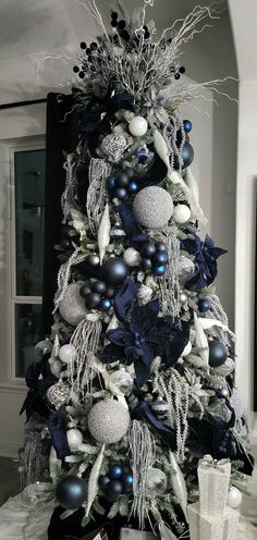 a decorated christmas tree with blue and silver ornaments